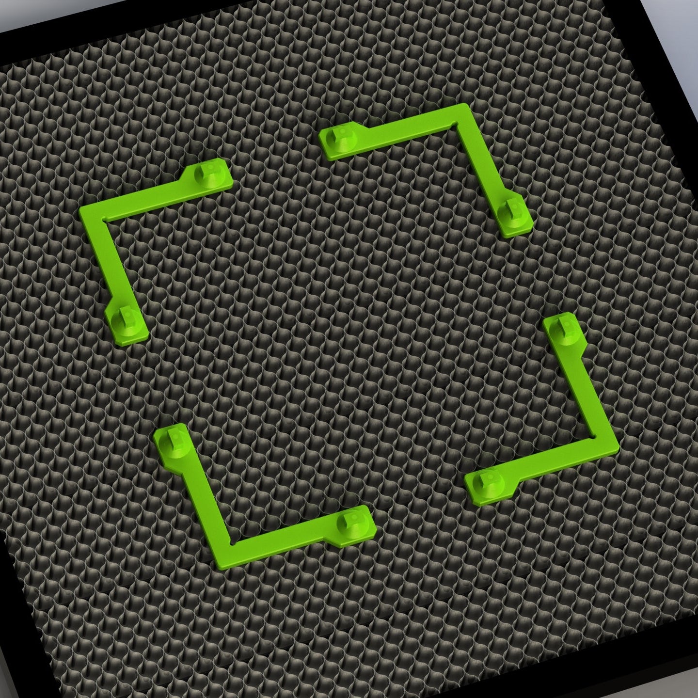 Green magnetic fixture holders on honeycomb laser bed.